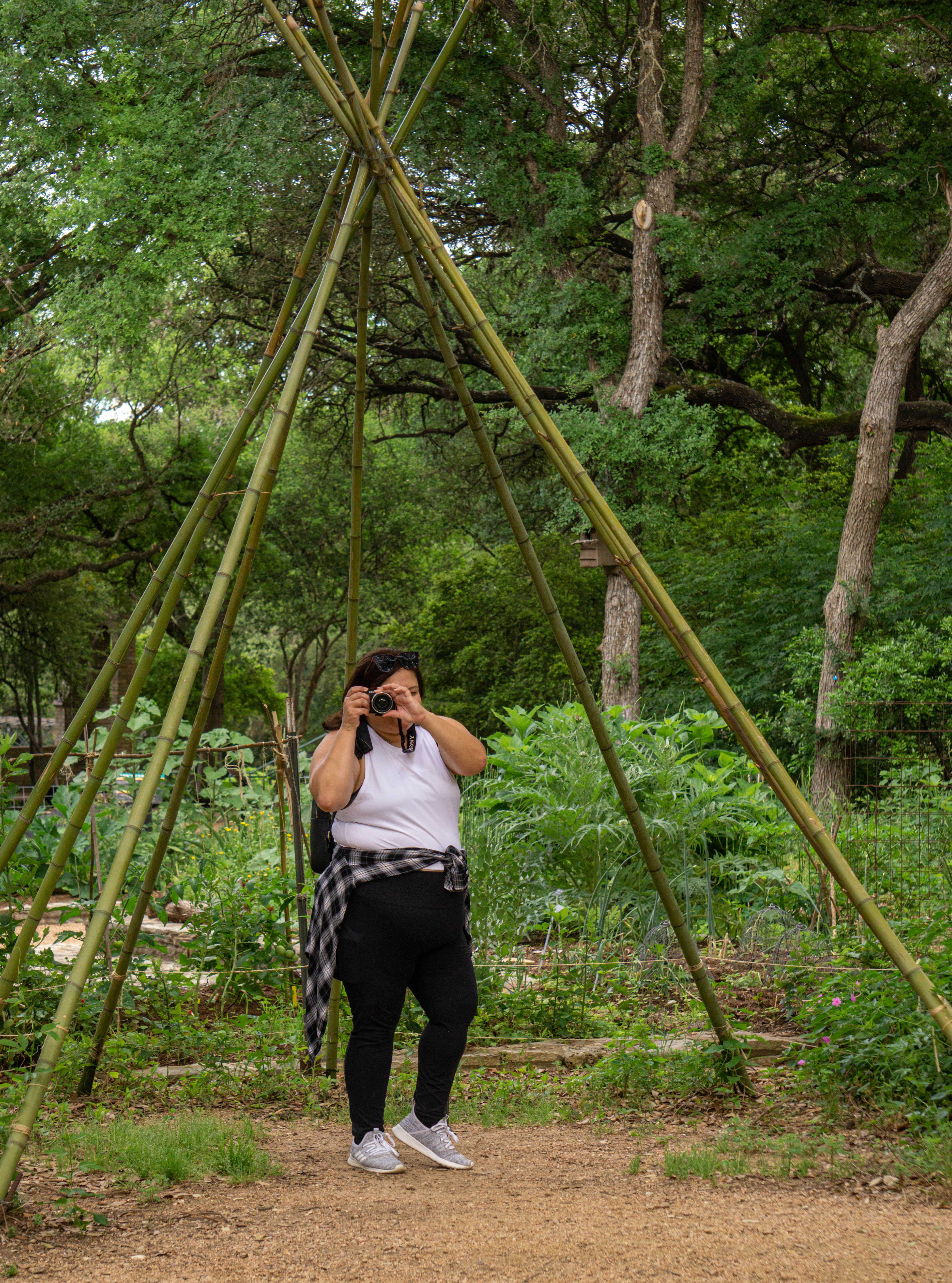 Ariel under a teepee in the park taking photos